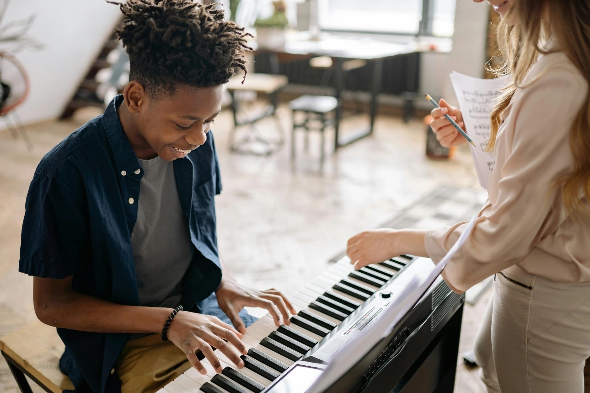 A piano lesson being shared between two members